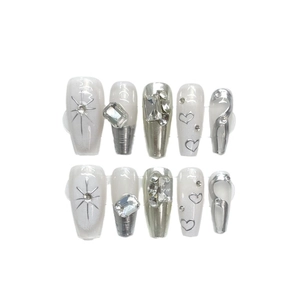 Handmade press-on nails with silver metal hearts and crystals on white French base