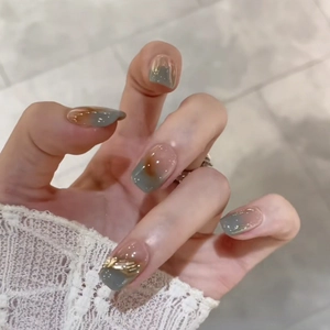 Short forest mist press-on nails with amber gradient and golden wire decoration