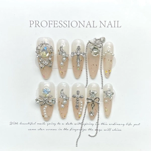 Fairy style stiletto press-on nails with pink gradient, glitter, chains and rhinestones