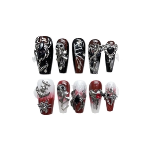 Gothic handmade press-on nails featuring 3D skull and spider charms on red-black gradient