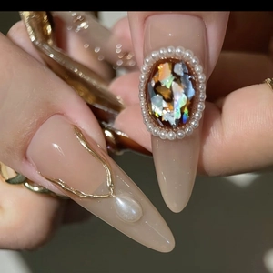 Baroque style press-on nails featuring vintage opal-like stones and pearl embellishments