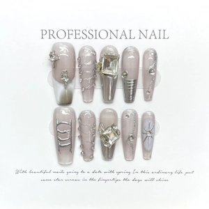 Handmade press-on nails with light purple base, silver crosses and sparkling crystals