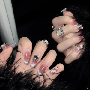 Pink cat eye press-on nails in long coffin shape with heart and bow jewelry accents