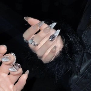 Sparkling long almond press-on nails with silver glitter, rhinestones, and large grey gems