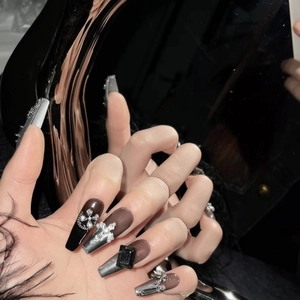 Handmade gothic dark press-on nails with silver crosses and chain details on long coffin shape