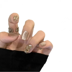 Champagne cat-eye press-on nails with sparkling rhinestones and glitter finish