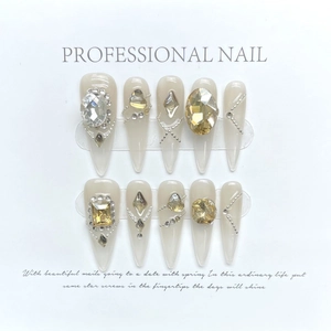 Handmade stiletto press-on nails in champagne gold with sparkling crystals and pearls