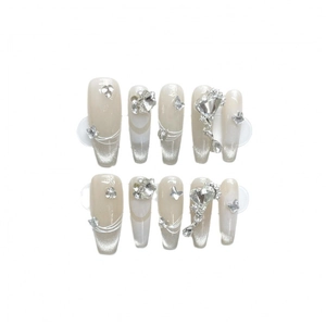 Handmade nude press-on nails with silver cat-eye effect, rhinestones and metal butterflies