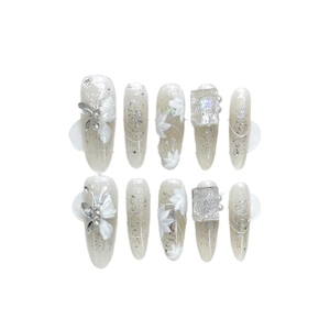 Handmade press-on nails with 3D white flowers, silver rhinestones and glitter finish