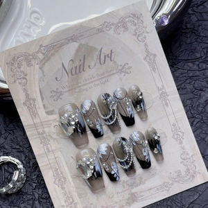 Luxurious black gradient press-on nails with white floral art, rhinestones, and pearls