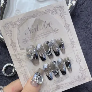 Luxurious black French press-on nails with silver rhinestones and white floral art