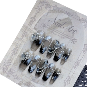 Dark smoky press-on nails with black gradient, hand-painted flowers, and rhinestone accents