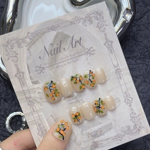 Hand-painted 3D persimmon press-on nails set in short square shape on display card