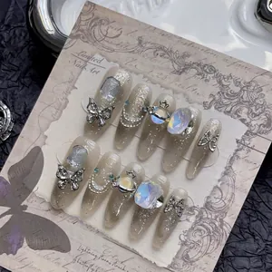Handmade almond press-on nails with 3D silver butterflies, star planets and rhinestones