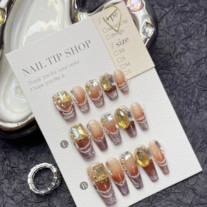 Brown cat-eye gradient press-on nails with luxury rhinestones and pearls on display card