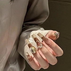 Long trapezoid press-on nails with brown marble design and champagne rhinestones