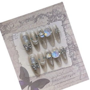 Handmade Y2K stiletto press-on nails with glitter, 3D butterfly, and planet rhinestone art