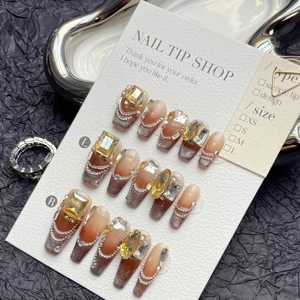 Brown cat eye press-on nails with luxury rhinestones and pearl chains in long coffin shape