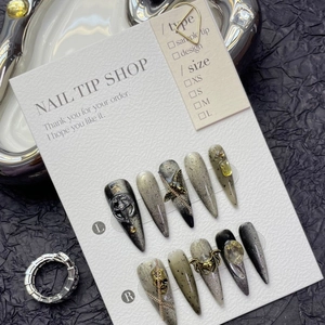 Gothic punk press-on nails set featuring black cat eye base with silver metal 3D charms