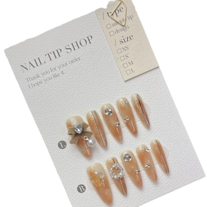 Handmade almond press-on nails in amber glaze with pearls, rhinestones and 3D bows