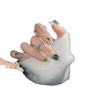 Green gemstone press-on nails with long trapezoid shape and sparkling crystal accents