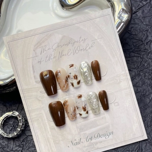 Brown amber handmade press-on nails with marble foil design and mid-long trapezoid shape