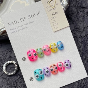 Detail view of colorful 3D googly eyes press-on nails with cartoon hand-painted expressions