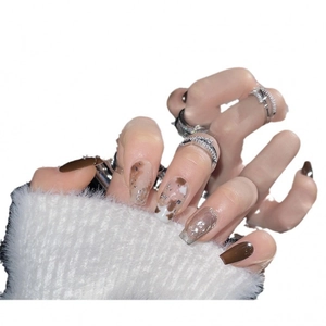 Brown amber marble press-on nails in long coffin shape with silver glitter accents