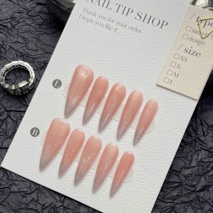 Pink cat-eye gradient stiletto press-on nails on size-labeled display card