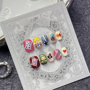 Handmade red circus press-on nails with poker art and cute 3D character design