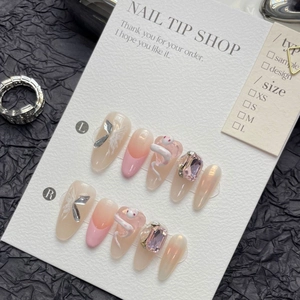 Pink aurora press-on nails set featuring 3D white snakes and rhinestones on black paper