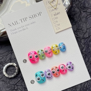 Handmade press-on nails with colorful glitter, cute 3D googly eyes, and cartoon designs