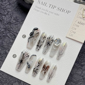 Handmade press-on nails with black butterflies and 3D snakes on milky white base