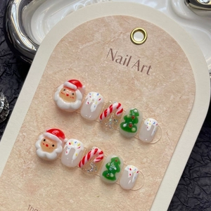 Handmade 3D Christmas press-on nails with Santa Claus and tree designs on display card