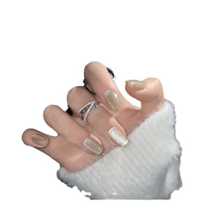 Elegant champagne cat-eye press-on nails with shimmering glitter on a model hand