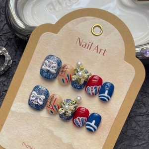 Handmade lion dance press-on nails with deep blue glitter, pearls and festive charms