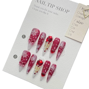 Handmade Christmas press-on nails set featuring red glitter, 3D bows, and snowflake patterns
