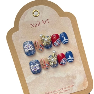 Handmade lion dance press-on nails with blue and red cat-eye finish and pearl charms