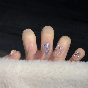Handmade press-on nails with 3D bows, glitter, and grid patterns in a sweet luxury style