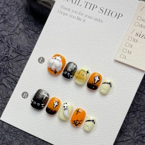 Handmade Halloween press-on nails with cute ghost, pumpkin, and black cat motifs