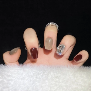 Deep red and silver sequin press-on nails with large rhinestones on a plush background
