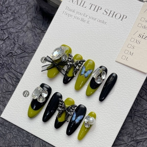Olive green and black press-on nails with metal butterfly and crystal rhinestones