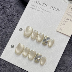 Short champagne cat eye press-on nails set with shimmering glitter and rhinestones