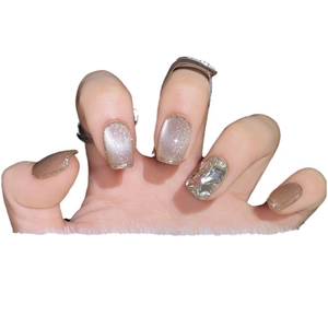 Handmade champagne cat eye press-on nails with glitter and large geometric rhinestone