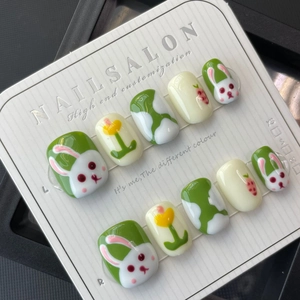 Handmade glossy press-on nails featuring cute white rabbit and carrot motifs in green