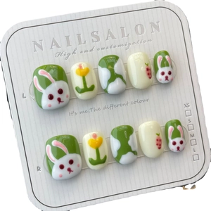 Handmade press-on nails with cute bunny, tulip, and strawberry designs in avocado green