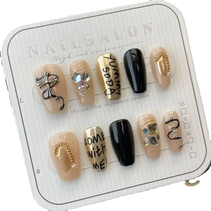 Handmade press-on nail set featuring chrome heart style metal cross and glitter