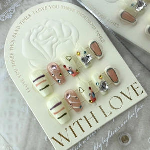 Handmade press-on nails with heart graffiti and rhinestones on rose display card
