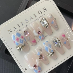 Sweet pink press-on nails with 3D angel wings, heart gems, and crystal accents on short coffin shape