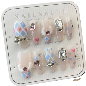 Handmade press-on nails with pink star wings and blue rhombs in long trapezoid shape
